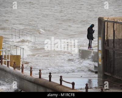 Sheerness, Kent, UK. 1st Feb, 2018. UK Weather: a young woman takes a surge tide selfie as the Neptune Jetty is covered by water during today's surge tide. Sunny spells but with a strong and cold westerly wind. Credit: James Bell/Alamy Live News Stock Photo