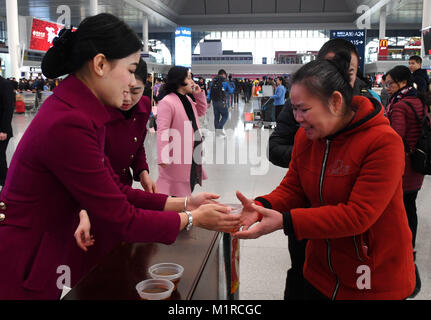 Nanning, China's Guangxi Province. 1st Feb, 2018. Staff members provide hot drinks to passengers at Nanning East Railway Station, in Nanning, south China's Guangxi Province, Feb. 1, 2018. The 2018 Spring Festival travel rush, known as the Chunyun, started on Thursday and will last till March 12. About 2.98 billion trips are expected to be made during the Chunyun. The Spring Festival, or Chinese Lunar New Year, falls on Feb. 16 this year. Credit: Zhang Ailin/Xinhua/Alamy Live News Stock Photo
