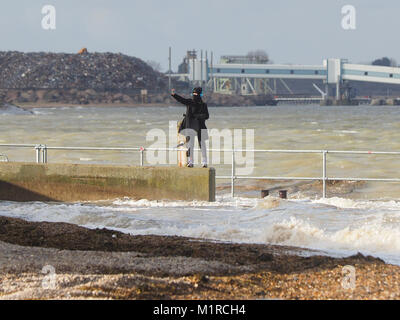 Sheerness, Kent, UK. 1st Feb, 2018. UK Weather: a young woman takes a surge tide selfie as the Neptune Jetty is covered by water during today's surge tide. Sunny spells but with a strong and cold westerly wind. Credit: James Bell/Alamy Live News Stock Photo