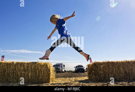 Las Vegas, Nevada, USA. 6th Mar, 2014. Cheyenne Olive, 7, of Nellis AFB jumps across hay bales following a Horses4Heroes ribbon-cutting ceremony and grand-opening event at Tule Springs in Las Vegas, Nevada. Credit: L.E. Baskow/ZUMA Wire/Alamy Live News Stock Photo