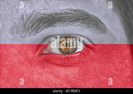 Human face and eye painted with flag of Poland Stock Photo