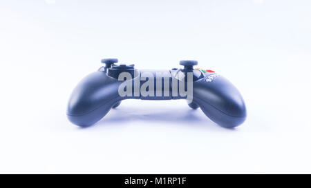 Closeup of black game controller or controller isolated on white background. Selective focus and crop fragment. Stock Photo