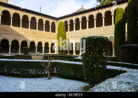 a view of the cloister of the medieval Monastery of Santa Maria de Ripoll, in Ripoll, Spain, covered with snow Stock Photo