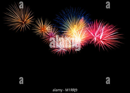 Colored firework background with free space for text. Colorful fireworks at night light up the sky with dazzling display. Use for abstract background. Stock Photo