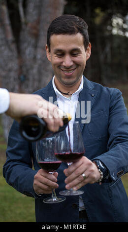Man with two glasses of wine before drinking them. Stock Photo