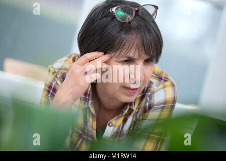 a senior woman suffering from headache Stock Photo