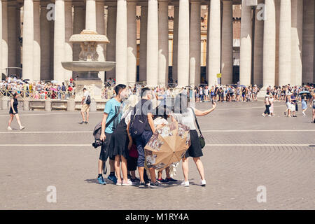 ROME - AUGUST 3: A group of Asian tourists do selfie in the Vatican area next to St. Peter's Cathedral August 3, 2017 in Rome, Italy Stock Photo