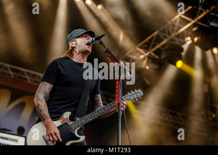 The Swedish punk rock band Millencolin performs a live concert at Koengen in Bergen. Here guitarist Mathias Färm is seen live on stage. Norway, 19/06 2011. Stock Photo