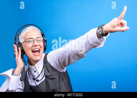 Senior business woman dancing to the beat of the music Stock Photo