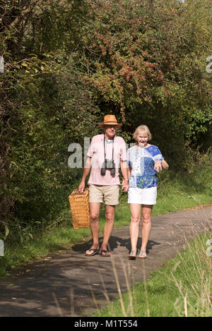 Elderly couple walking along the towpath of the Wilts and Berks canal near Swindon UK. Stock Photo