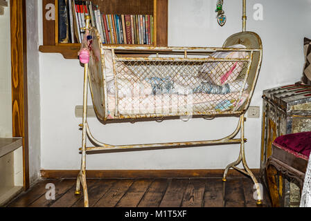 Antique metal baby cradle vintage interior Stock Photo