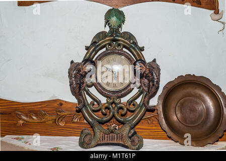 Old antique fireplace clock and bronze plate closeup Stock Photo