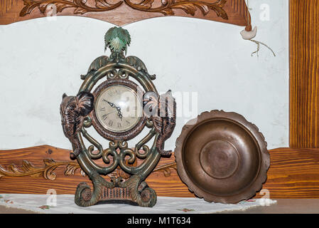 Old antique fireplace clock and bronze plate closeup Stock Photo