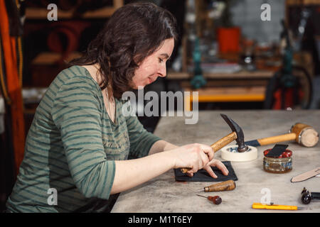 Working process in the leather workshop. Stock Photo