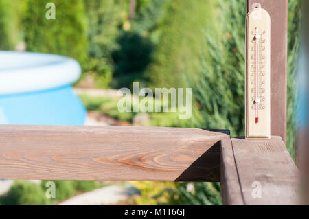 Wooden garden thermometer on a street in a country house Stock Photo