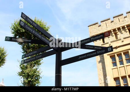 London, United Kingdom - August 26 2017: A sign post in the grounds of the Tower of London, depicting directions to the Crown Jewels. Stock Photo