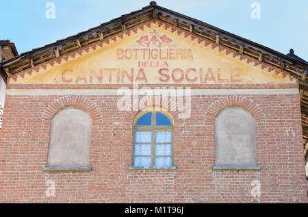BAROLO, ITALY - AUGUST 6: Wine cellar and shop old sign painted on red bricks building facade on August 6, 2016 in Barolo, Italy. Stock Photo