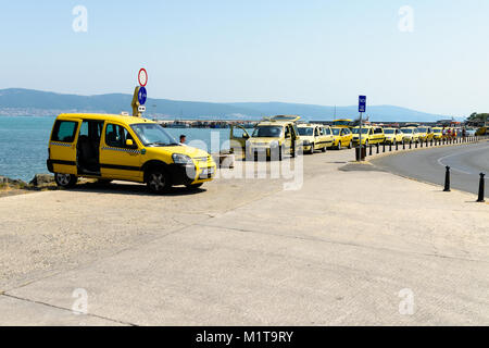 Nesebar, Bulgaria - July 07, 2017: Row of taxis in a taxi rank awaiting for customers Stock Photo