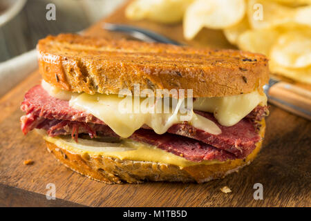 Savory Homemade Corned Beef Reuben Sandwich with Mustard and Cheese Stock Photo