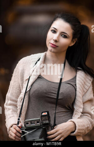 Beautiful Young Woman Holding Vintage Old Camera, classic retro style photograph Stock Photo