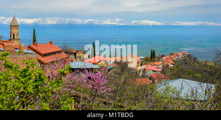 city of Signakhi in the mountains of Georgia, red tile roofs of brick houses against the background of the Alazani valley and snow-covered tops of mou Stock Photo