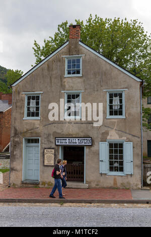 Tourists walk past the White Hall Tavern, in Harper's Ferry National Historic Park, Jefferson County, West Virginia, United States. Stock Photo