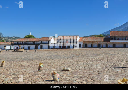 BOYACA, COLOMBIA - JANUARY 23, 2014: A view of some buildings and mountains from the main square of Villa de Leyva, Colombia. Stock Photo