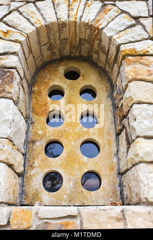 old stone window with round holes Stock Photo