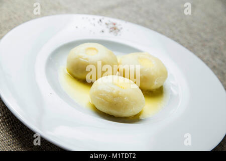Three potato dumplings on a plate Stock Photo