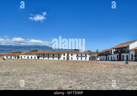 BOYACA, COLOMBIA - JANUARY 23, 2014: A view of some buildings and mountains from the main square of Villa de Leyva, Colombia. Stock Photo