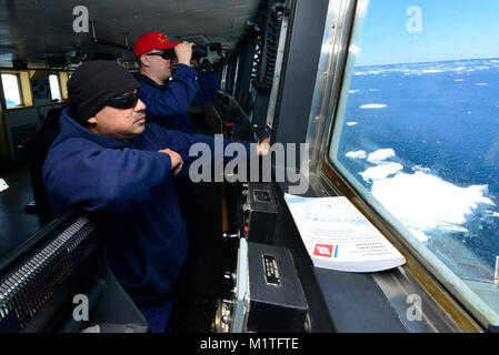 Senior Chief Petty Officer Jose Segura and Chief Petty Officer Josh Dehaan, boatswain’s mates aboard the Coast Guard Cutter Polar Star, stand watch on the bridge while transiting through ice below the Antarctic Circle on Sunday, Jan. 7, 2018. The crew of the Seattle-based Polar Star is on its way to Antarctica in support of Operation Deep Freeze 2018, the U.S. military’s contribution to the National Science Foundation-managed U.S. Antarctic Program. U.S. Coast Guard Stock Photo