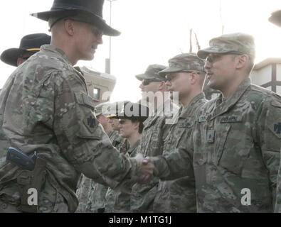 Oklahoma Army National Guardsman, Sgt. Michael Bolgrin, religious affairs non-commissioned officer with 1st Squadron, 180th Cavalry Regiment, 45th Infantry Brigade Combat Team, receives his Thunderbird combat patch alongside more than 350 of his peers during a time-honored ceremony held January 2018 in Kabul, Afghanistan. For Bolgrin, earning the Thunderbird combat patch holds sentimental value, as his grandfather fought in WWII and the Korean War with the 45th Infantry Division. Nearly 500 members of the 180th are currently deployed to Afghanistan in support of the NATO-led train, advise and  Stock Photo