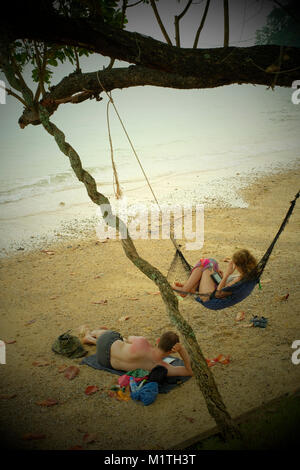 Young couple rest on the beach in koh Yao Noi, a Thai island in the Andaman Sea. 20-Jan-2018 Stock Photo