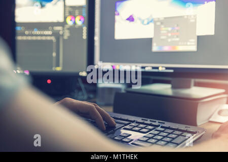 post production - man doing photo and video editing on computer Stock Photo