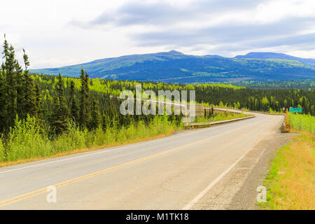 From North to South - driving on Elliot Highway through green hills to Fairbanks, Alaska. Stock Photo