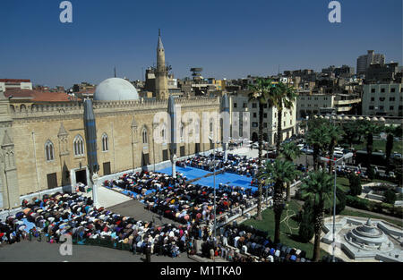 Egypt, Cairo. Friday prayers in front of mosque of Sayyidna-al-Hussein. Stock Photo