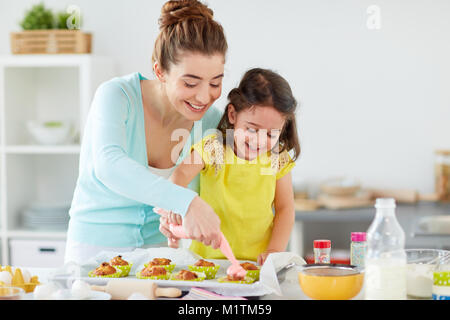 mother and daughter cooking cupcakes at home Stock Photo