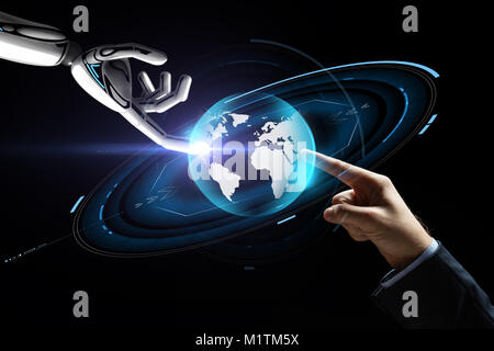 human and robot hand with virtual earth hologram Stock Photo