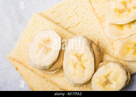 Light Healthy Snack made from Banana Slices, Cashew Butter and Gluten Free Crispbreads Stock Photo