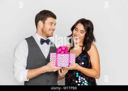 happy couple with gift box at birthday party Stock Photo