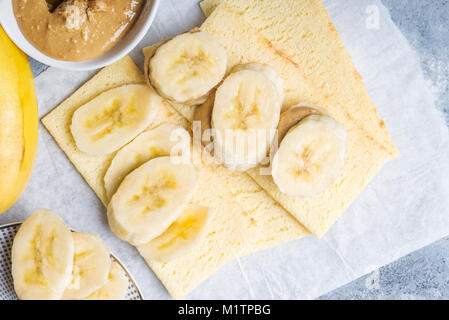 Light Healthy Snack made from Banana Slices, Cashew Butter and Gluten Free Crispbreads Stock Photo