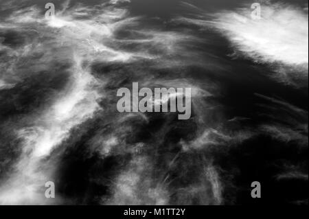 Cirrus clouds wisps of light clouds with natural patterns in black and white. Stock Photo