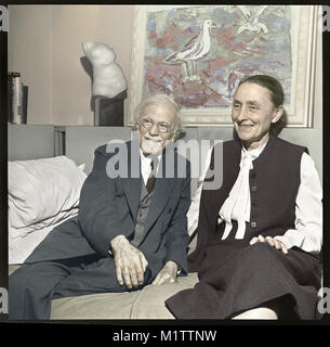 Photographer Alfred Stieglitz and artist Georgia O’Keeffe in New York City. The married couple are at 'An American Place' for an exhibition of John Marin in 1942. Artwork on wall is “Sea and Gulls” by Marin. Stock Photo