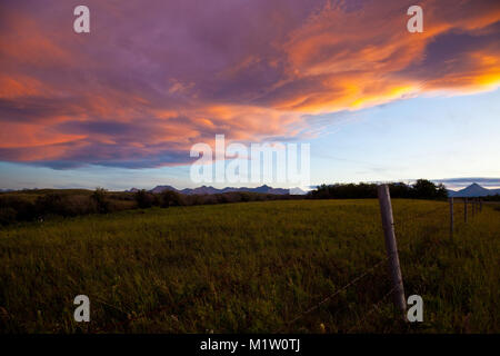 Sunset over ranch country  and the Rocky Mountains in Southern Alberta, Canada Stock Photo