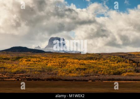 Chief Mountain in Autumn with layers of aspen trees with fall colors in Glacier National Park, Montana, USA Stock Photo