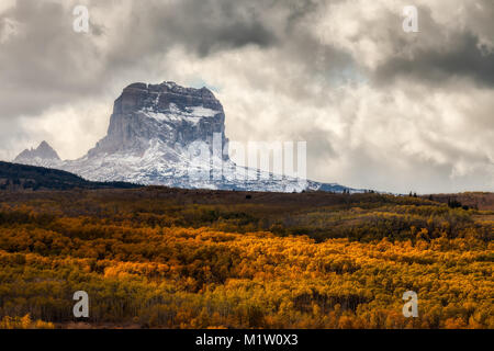 Chief Mountain in Autumn with layers of aspen trees with fall colors in Glacier National Park, Montana, USA Stock Photo