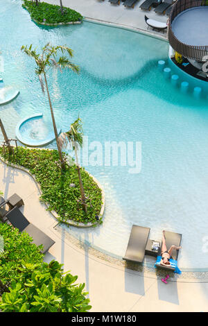 PATTAYA, THAILAND - April 20, 2016: Woman relaxing in a swimming pool. Summer Vacations, at the Centra Maris Resort. It is luxury hotel, Large swimmin Stock Photo