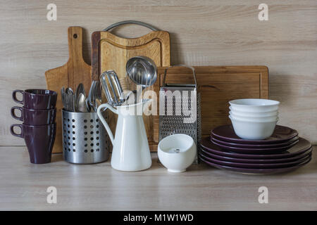 Kitchen still life as background for design. Crockery, tableware and other different stuff on wooden table-top. Image with copy space. Stock Photo