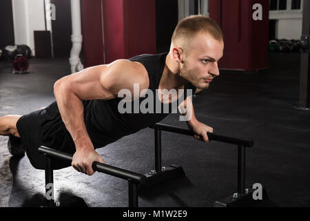 Young Athlete Man Doing Push-up Exercise In The Gym Stock Photo