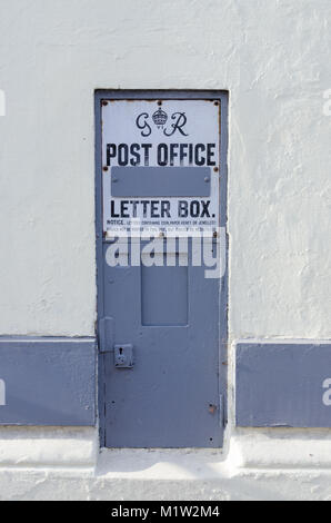 Old disused wall-mounted letterbox painted grey in the worcestershire town of Upton upon Severn Stock Photo